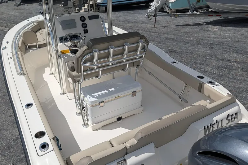 Slide: The Image of 2022 Key West 219 FS boat interior with helm, seating, and cooler. - 6