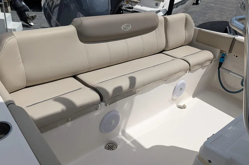 Slide: The Image of 2022 Key West 219 FS boat interior with beige seating and built-in speakers. - 7