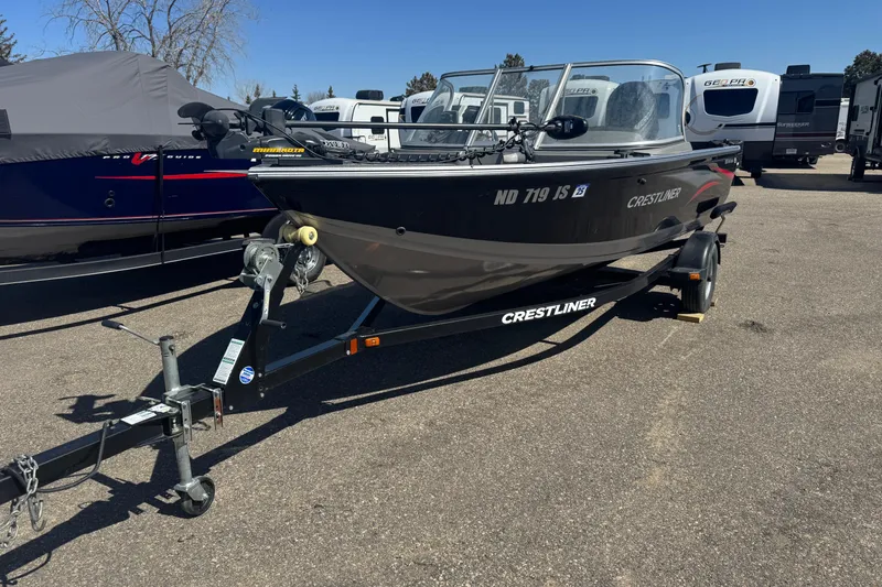 The Image of 2014 Crestliner 1650 Fish Hawk boat on trailer in parking lot. - 1