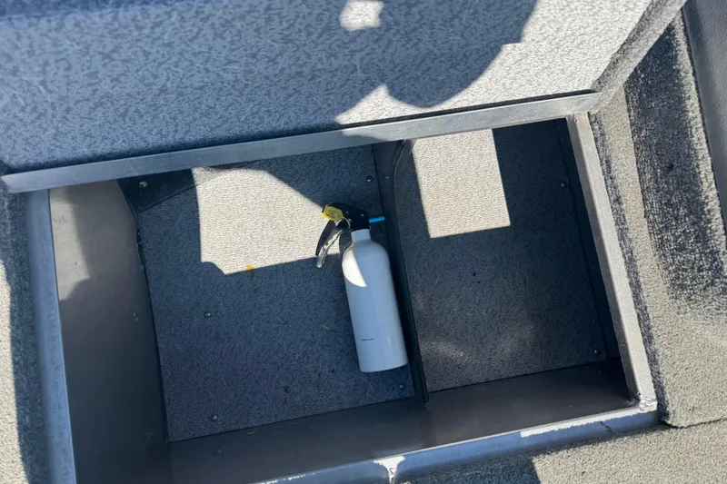 Slide: The Image of Storage compartment in 2014 Crestliner 1650 Fish Hawk boat with fire extinguisher. - 15