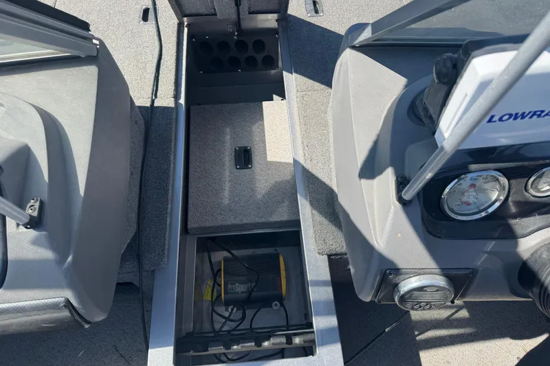 Slide: The Image of 2014 Crestliner 1650 Fish Hawk boat interior with storage compartment and Lowrance electronics. - 16