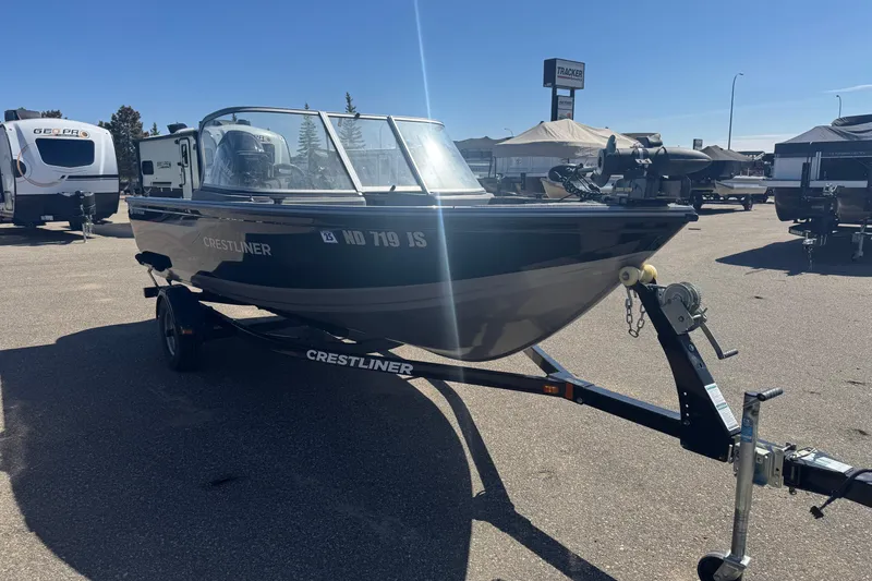 Slide: The Image of 2014 Crestliner 1650 Fish Hawk boat on trailer in outdoor lot. - 2