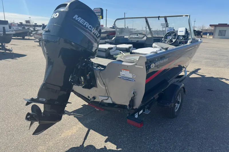 Slide: The Image of 2014 Crestliner 1650 Fish Hawk boat with Mercury outboard motor in a parking lot. - 3