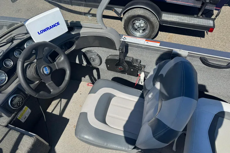 Slide: The Image of 2014 Crestliner 1650 Fish Hawk boat interior with steering wheel and Lowrance device. - 5