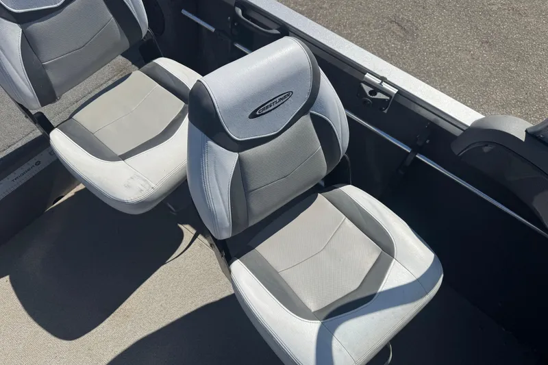 Slide: The Image of 2014 Crestliner 1650 Fish Hawk boat seats, gray and white upholstery, interior view. - 7