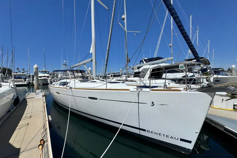 The Image of 2008 Beneteau 49 yacht docked at marina under clear blue sky. - 1
