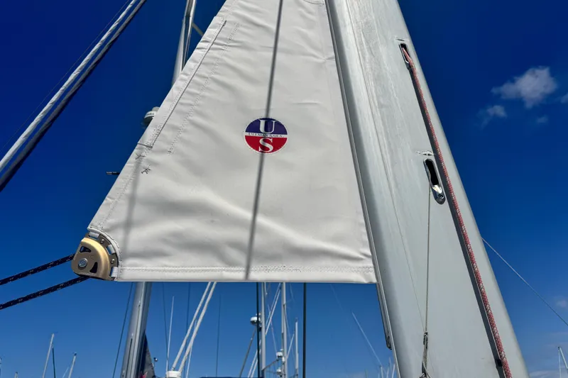 Slide: The Image of Sail of a 2008 Beneteau 49 yacht against a clear blue sky. - 12