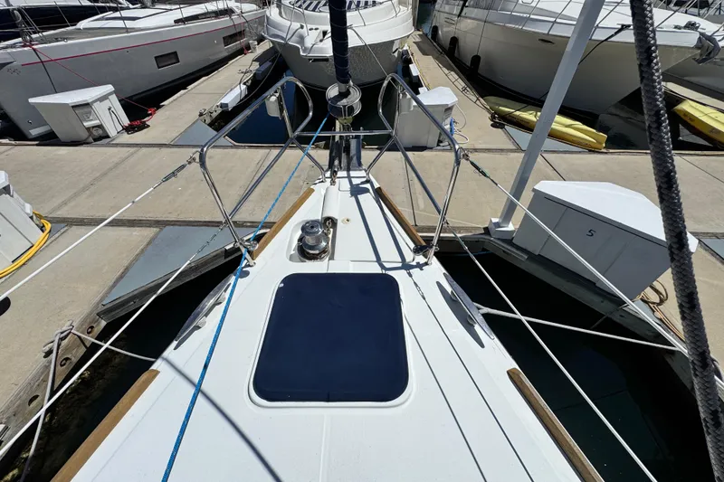 Slide: The Image of Deck view of a 2008 Beneteau 49 yacht docked at a marina. - 13