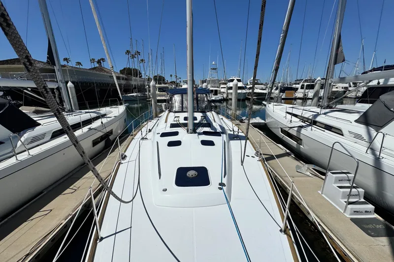 Slide: The Image of 2008 Beneteau 49 sailboat docked at marina, surrounded by other yachts. - 14