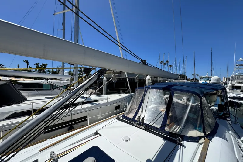 Slide: The Image of Sailboat Beneteau 49, 2008 model, docked at marina under clear blue sky. - 16