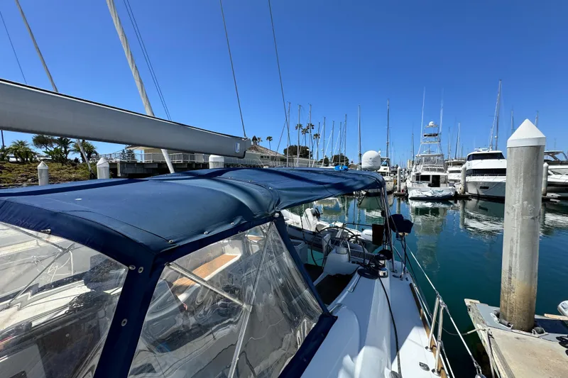 Slide: The Image of 2008 Beneteau 49 sailboat docked in a marina under clear blue skies. - 17