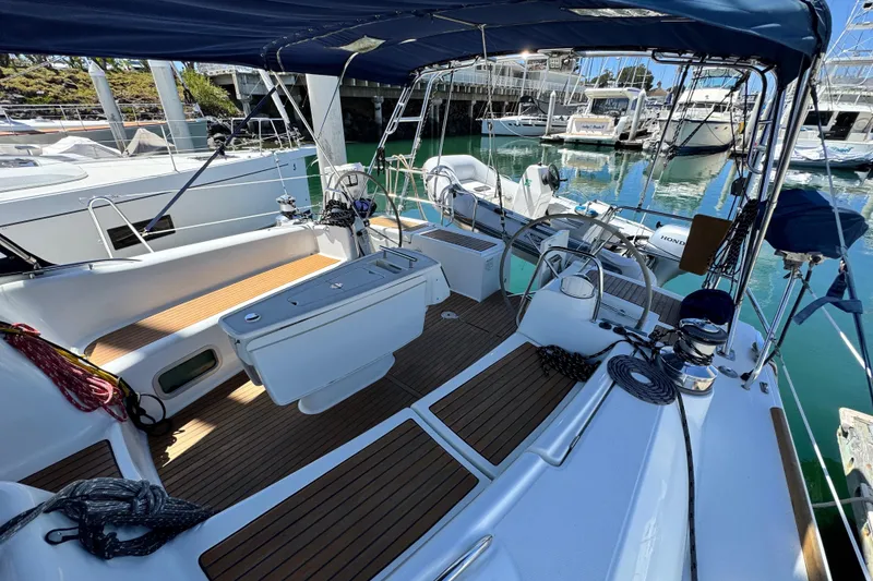 Slide: The Image of 2008 Beneteau 49 sailboat cockpit with teak flooring and marina view. - 18