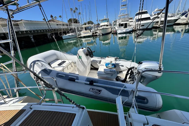 Slide: The Image of A 2008 Beneteau 49 yacht with an inflatable dinghy and Honda motor in a marina. - 19