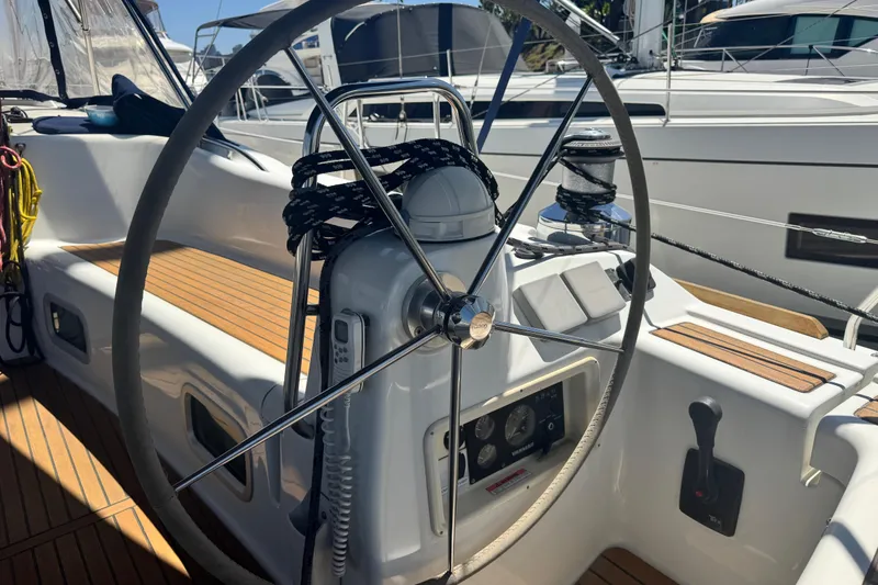 Slide: The Image of Steering wheel of a 2008 Beneteau 49 yacht with teak deck details. - 22