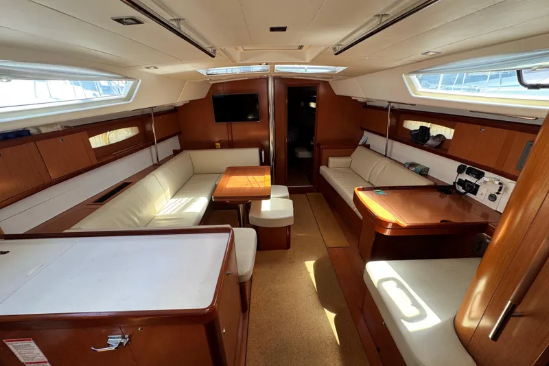 Slide: The Image of Luxurious interior of a 2008 Beneteau 49 yacht with elegant wood finishes and comfortable seating. - 28