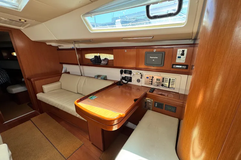 Slide: The Image of 2008 Beneteau 49 yacht interior with navigation station and seating area. - 29