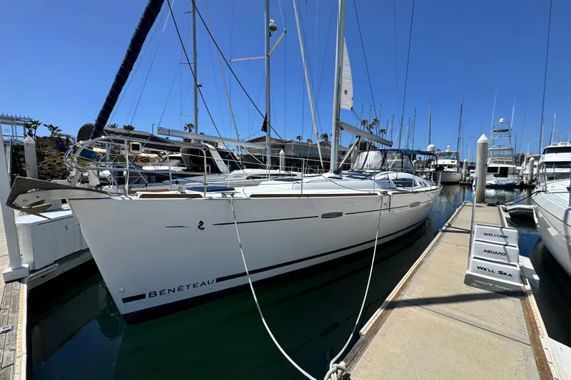 Slide: The Image of 2008 Beneteau 49 sailboat docked at marina under clear blue sky. - 3