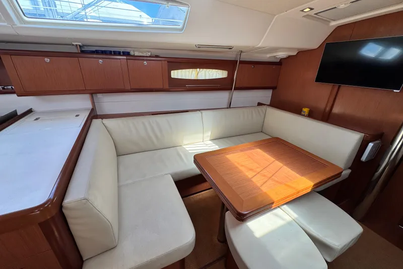 Slide: The Image of Luxurious interior of a 2008 Beneteau 49 yacht with elegant seating and wooden table. - 33