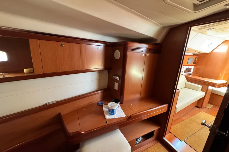 Slide: The Image of Interior of 2008 Beneteau 49 yacht with wooden cabinetry and seating area. - 36