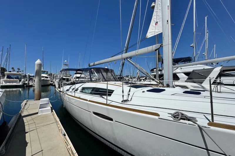 Slide: The Image of Sailboat docked at marina, 2008 Beneteau 49, clear blue sky background. - 4