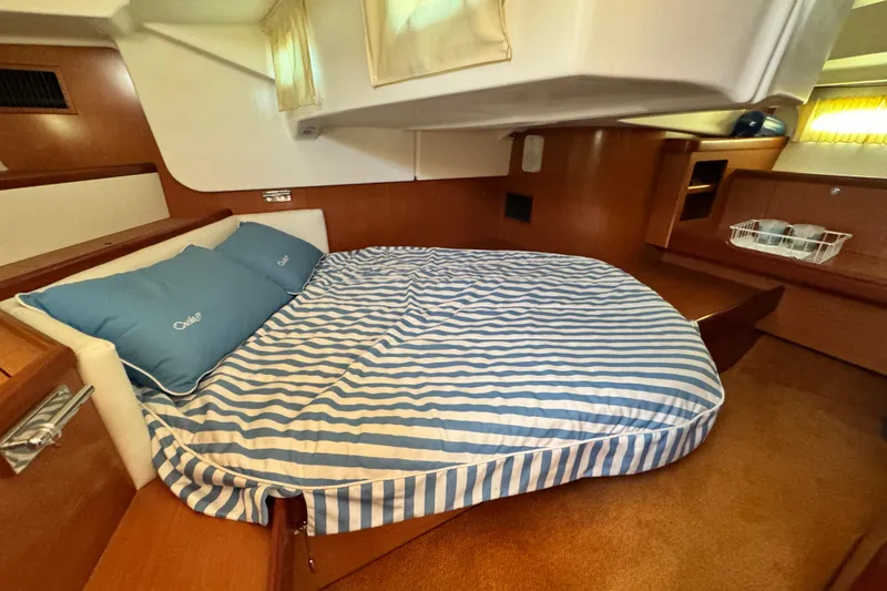 Slide: The Image of Cozy cabin interior of 2008 Beneteau 49 yacht with striped bedding. - 42
