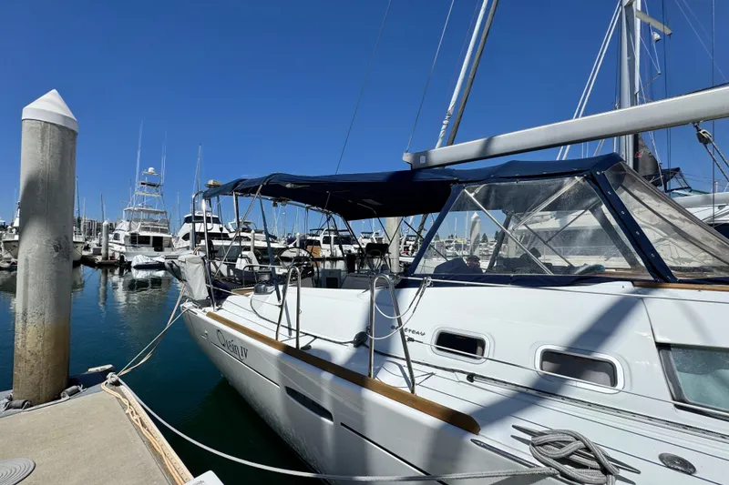 Slide: The Image of 2008 Beneteau 49 sailboat docked at marina under clear blue sky. - 5