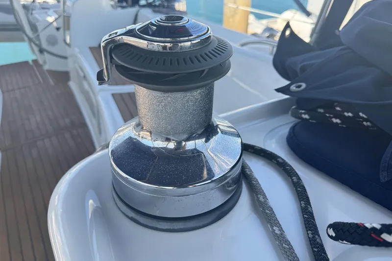 Slide: The Image of Winch on 2008 Beneteau 49 sailboat deck, with ropes and wooden flooring visible. - 50