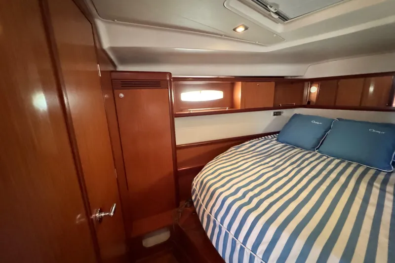 Slide: The Image of Luxurious cabin interior of 2008 Beneteau 49 yacht with striped bedding. - 51