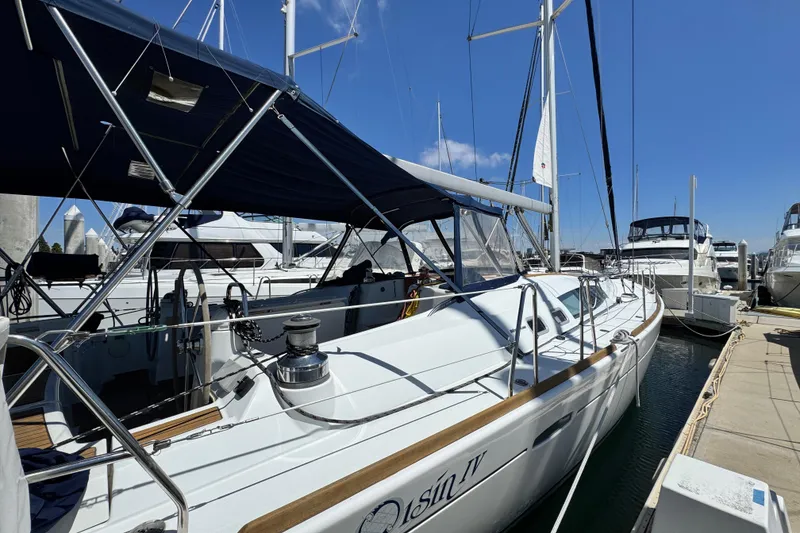 Slide: The Image of 2008 Beneteau 49 sailboat docked at marina under clear blue sky. - 6