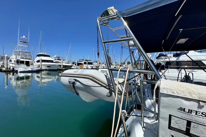 Slide: The Image of 2008 Beneteau 49 yacht docked in marina with inflatable dinghy and clear blue sky. - 7