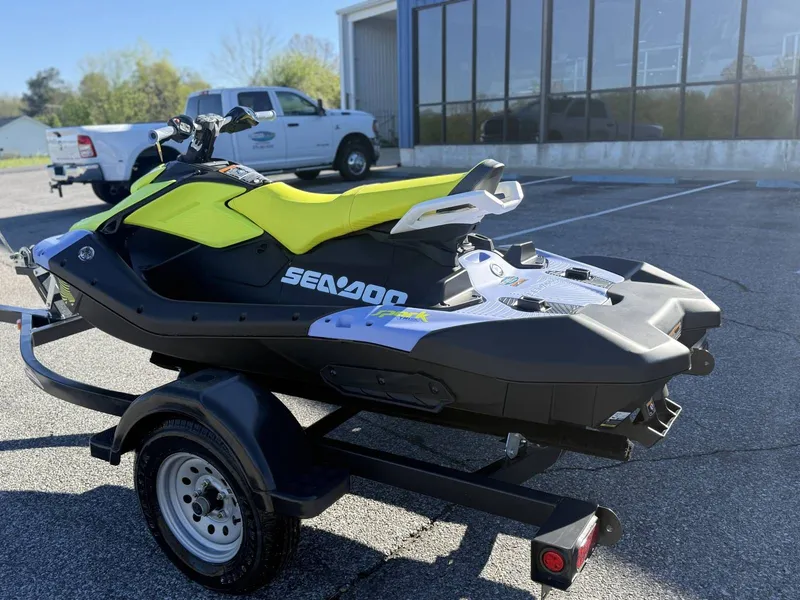 Slide: The Image of 2024 Sea-Doo Spark 3up Trixx on trailer outdoors. - 20