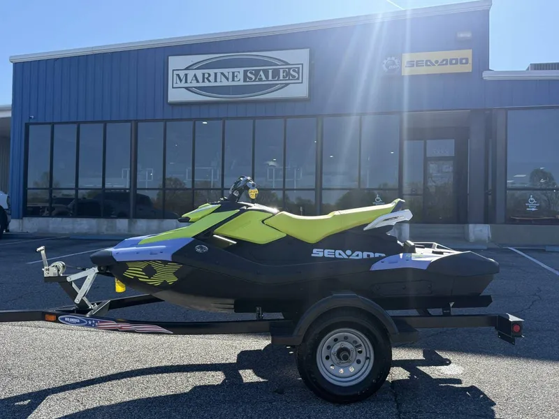 Slide: The Image of 2024 Sea-Doo Spark 3up Trixx in front of Marine Sales building. - 3