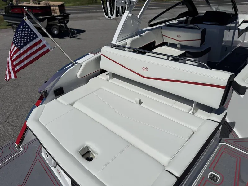 Slide: The Image of 2026 Cobalt R6 Surf boat with American flag, luxurious white upholstery. - 32
