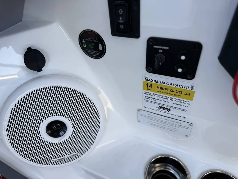Slide: The Image of Cobalt R6 Surf 2026 boat control area with speaker and capacity label. - 37