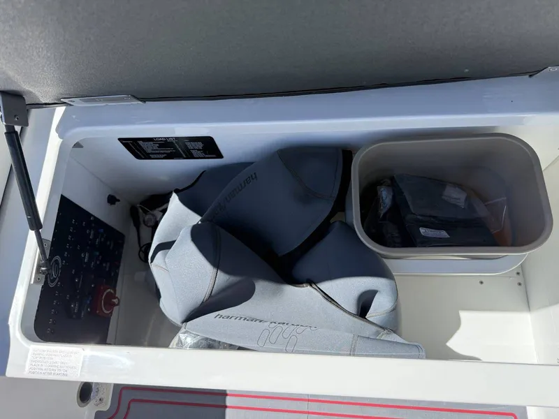 Slide: The Image of Storage compartment in 2026 Cobalt R6 Surf with wetsuit. - 48