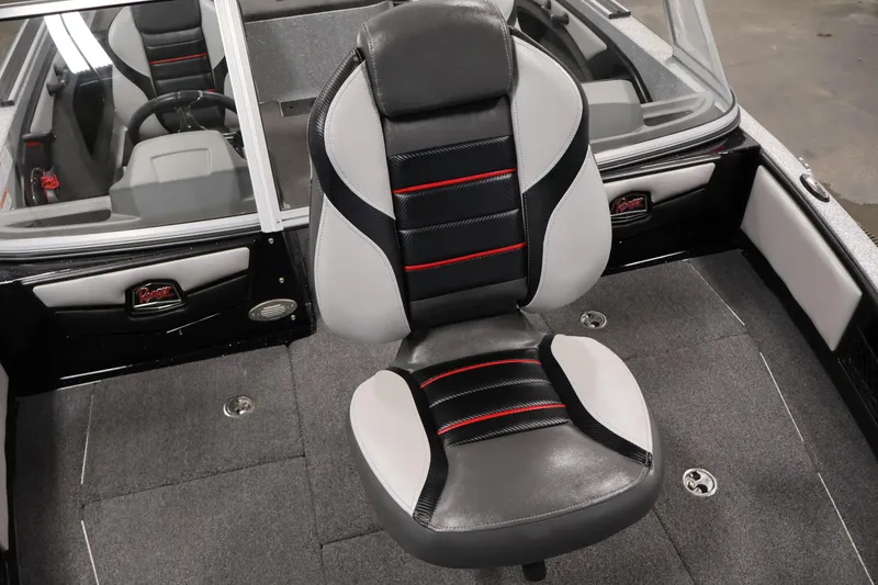 Slide: The Image of 2022 Ranger 1880MS boat interior with black and gray seating, red accents, and steering wheel. - 15