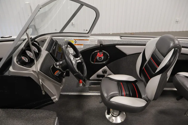 Slide: The Image of 2022 Ranger 1880MS boat interior with steering wheel and cushioned seats. - 20