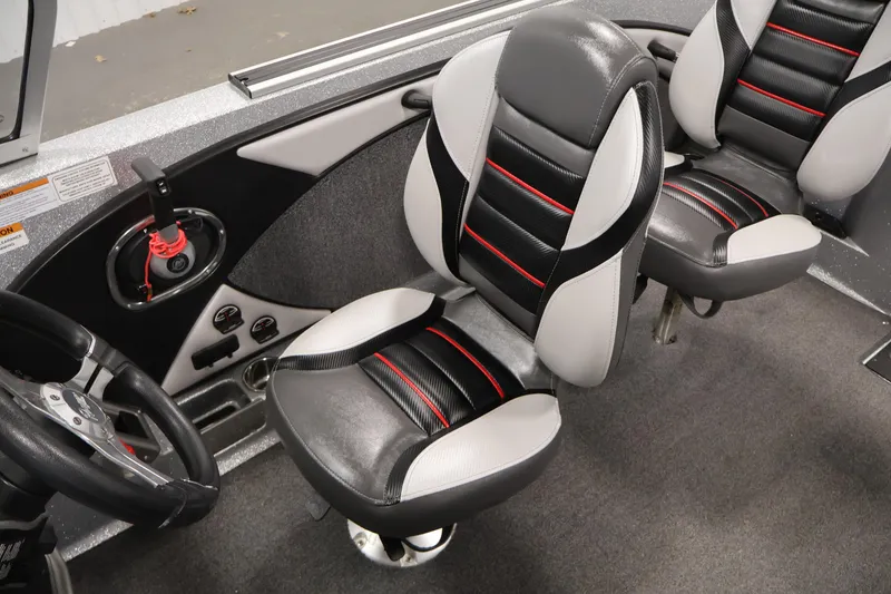 Slide: The Image of 2022 Ranger 1880MS boat interior with black and gray seats, steering wheel, and controls. - 26