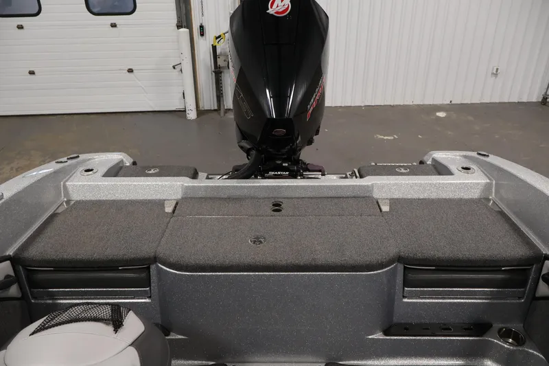 Slide: The Image of 2022 Ranger 1880MS boat interior with motor, gray seating, and storage compartments. - 32