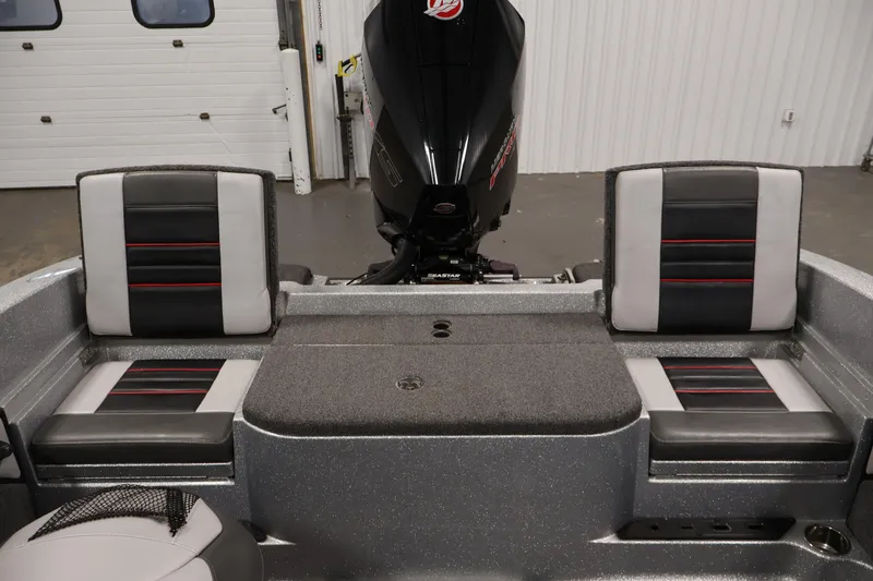 Slide: The Image of 2022 Ranger 1880MS boat interior with dual seats and motor in a garage setting. - 33