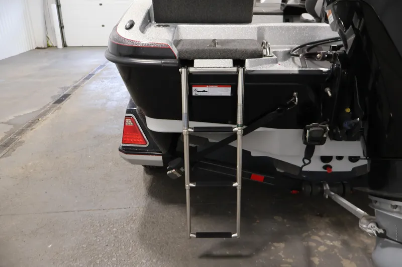 Slide: The Image of 2022 Ranger 1880MS boat with rear ladder in a garage setting. - 37