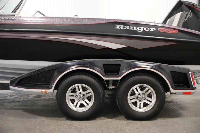 Slide: The Image of 2022 Ranger 1880MS boat on trailer, showcasing sleek design and dual wheels. - 48