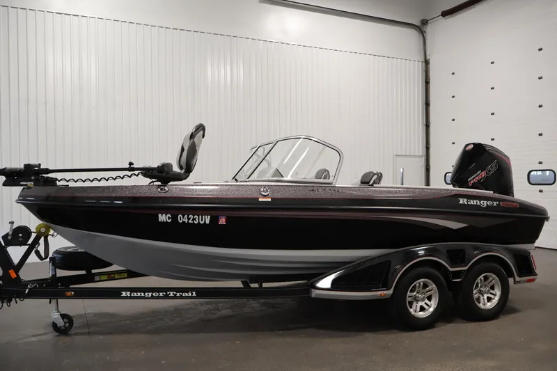 Slide: The Image of 2022 Ranger 1880MS boat in a garage, black exterior, on a trailer. - 7