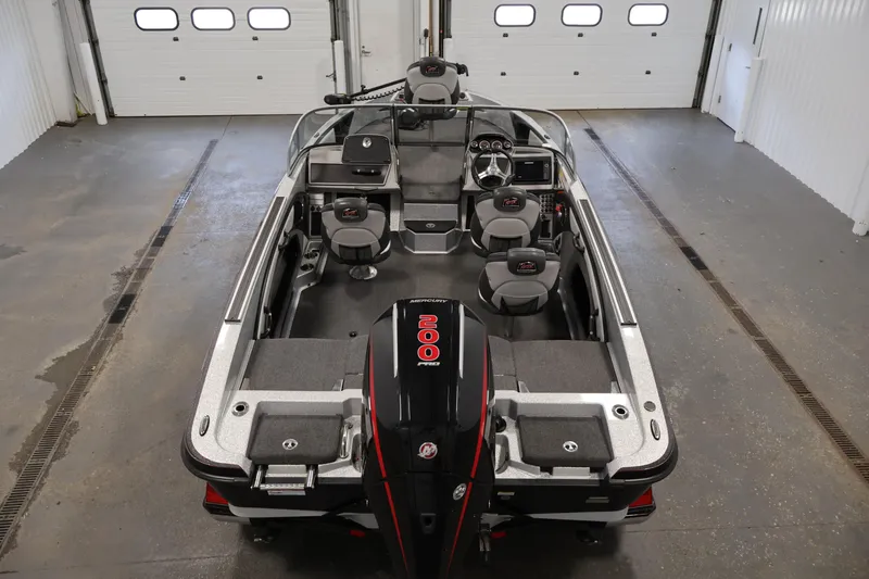 Slide: The Image of 2022 Ranger 1880MS boat interior with seating and controls in a garage setting. - 9
