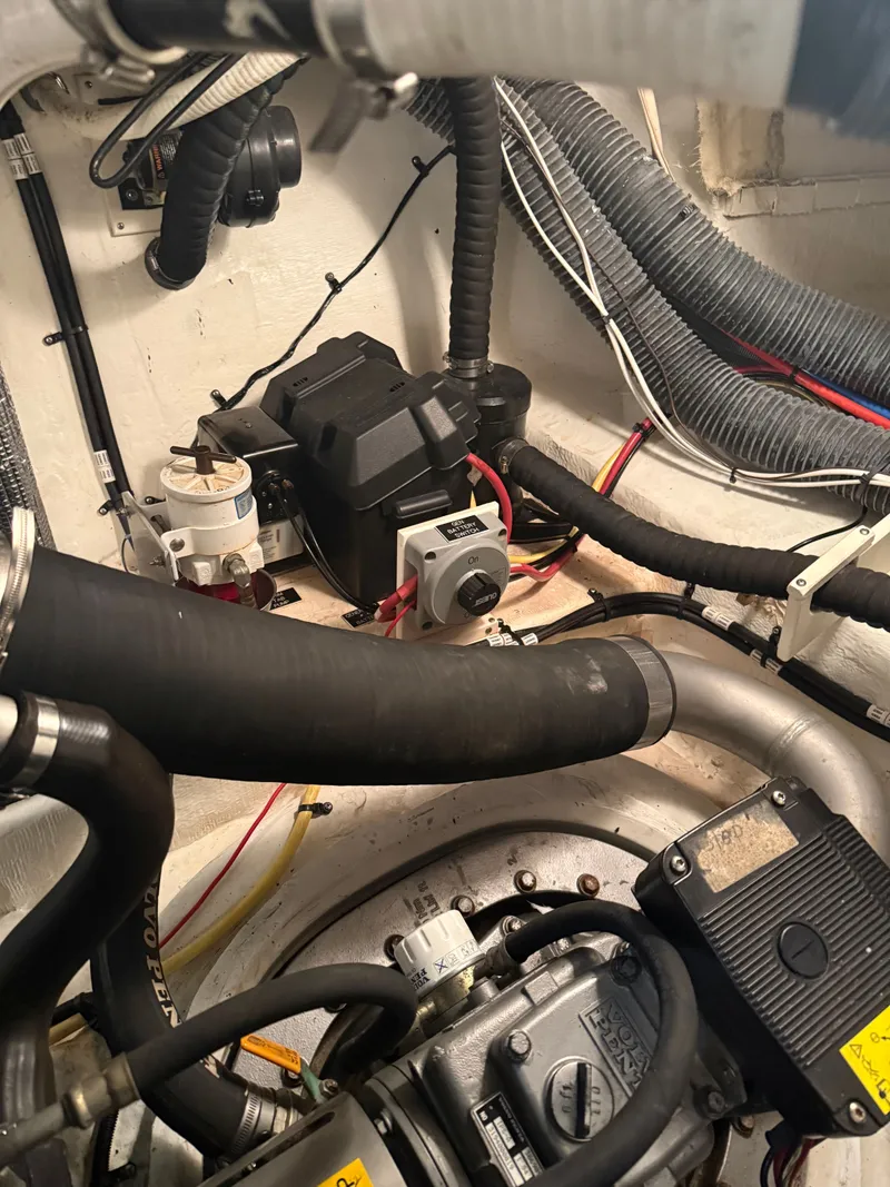 Slide: The Image of Engine room of 2006 Cruisers Yachts 420 Express with hoses and cables. - 23