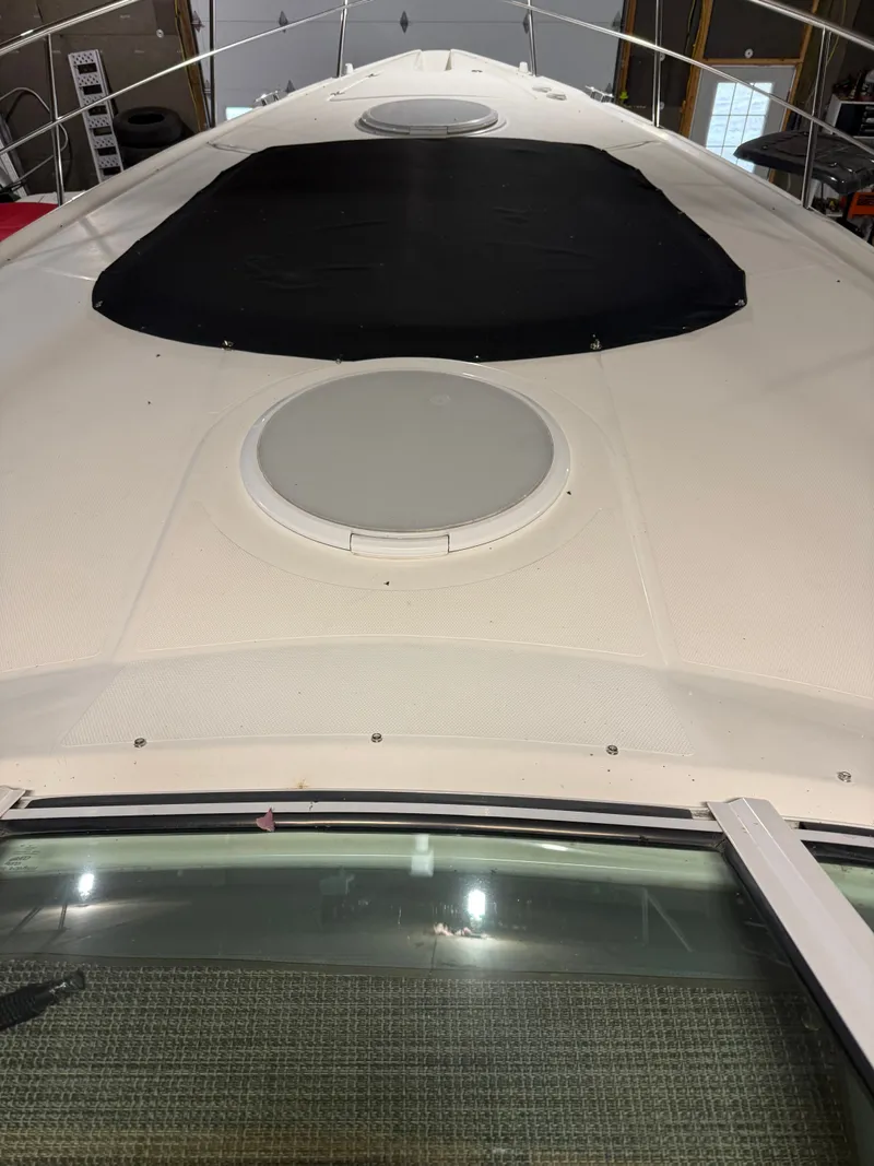 Slide: The Image of 2006 Cruisers Yachts 420 Express boat deck with black cover. - 24