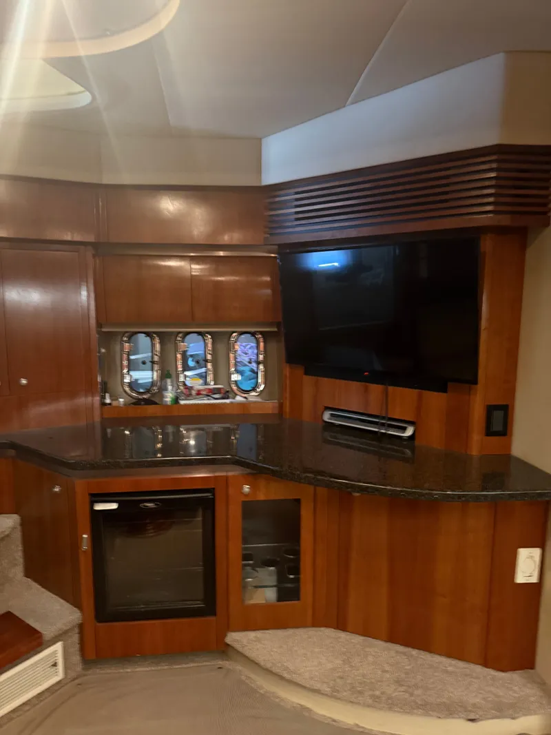 Slide: The Image of Interior of 2006 Cruisers Yachts 420 Express with TV and wood paneling. - 3