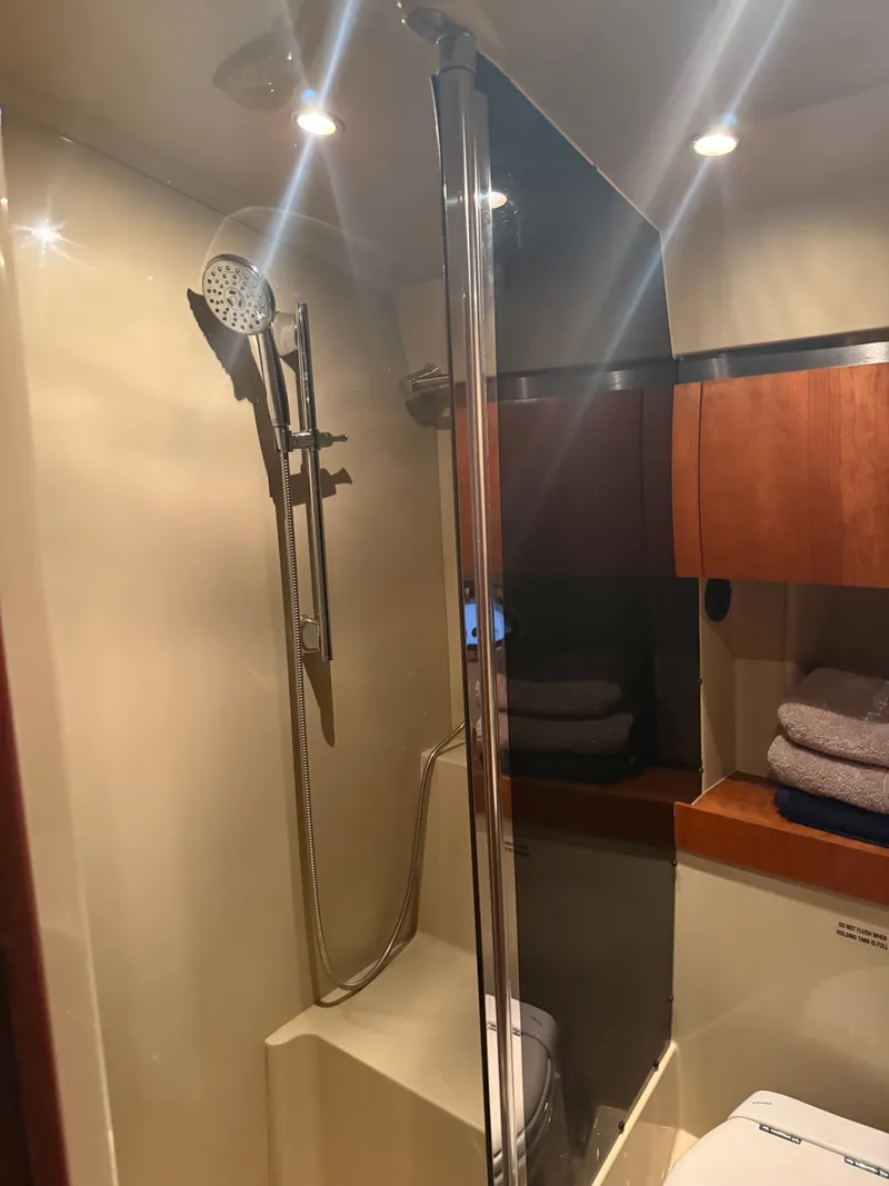 Slide: The Image of Interior of 2006 Cruisers Yachts 420 Express with shower and wooden cabinets. - 7