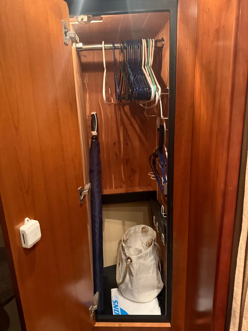 Slide: The Image of Closet in 2006 Cruisers Yachts 420 Express with hangers and bag. - 8