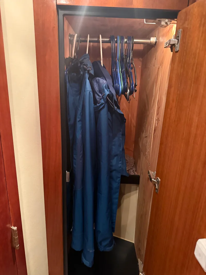 Slide: The Image of Closet in 2006 Cruisers Yachts 420 Express with blue jackets. - 9